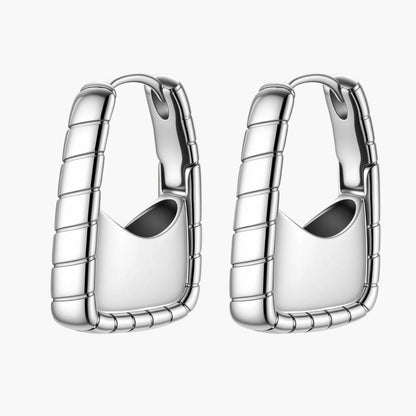 Close-up of platinum-plated sterling silver hoop earrings with horizontal textured grooves on white background.