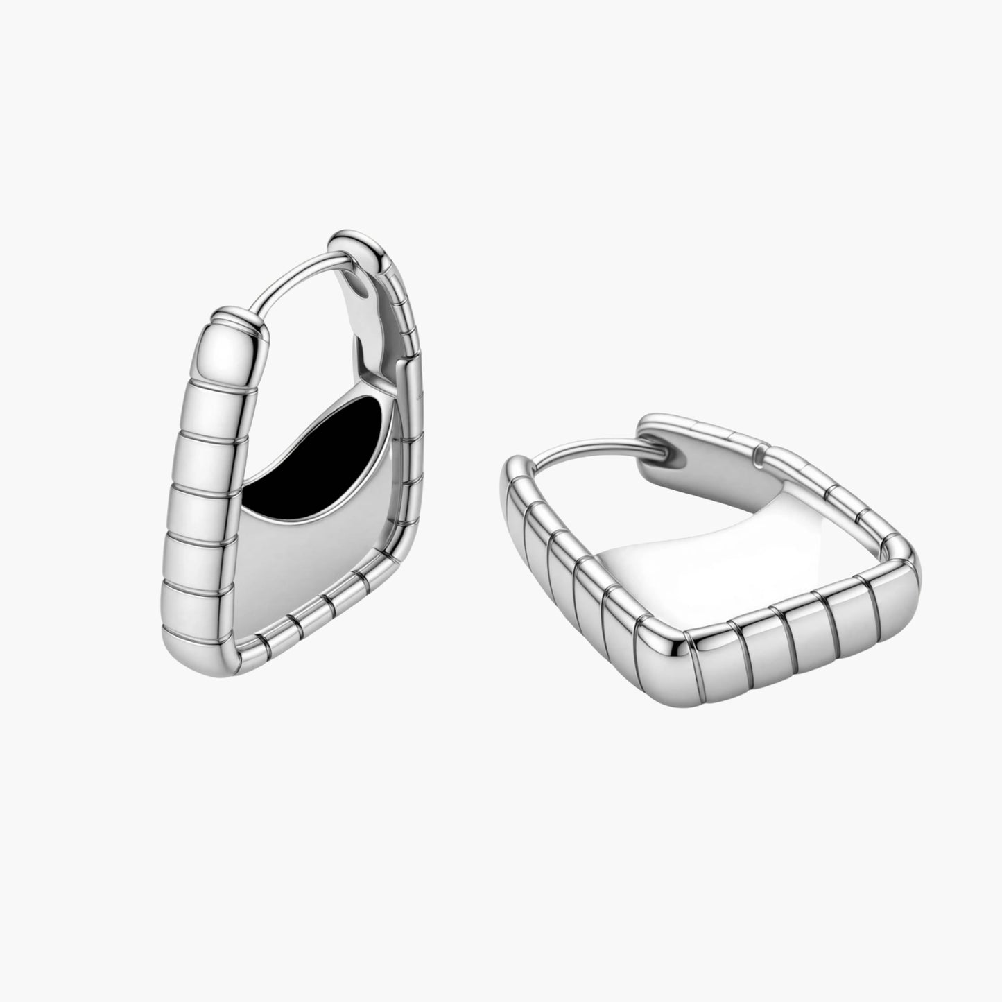 Close-up of platinum-plated sterling silver hoop earrings with horizontal textured grooves on white background.