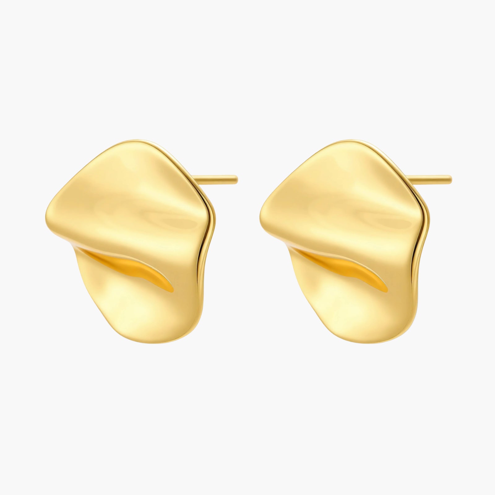 Close-up of organic gold-plated sterling silver stud earrings with flowing sculptural design and curved cut-outs