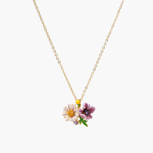 Gold-plated necklace with pink and purple enamel flower pendant featuring crystal accents on cream background