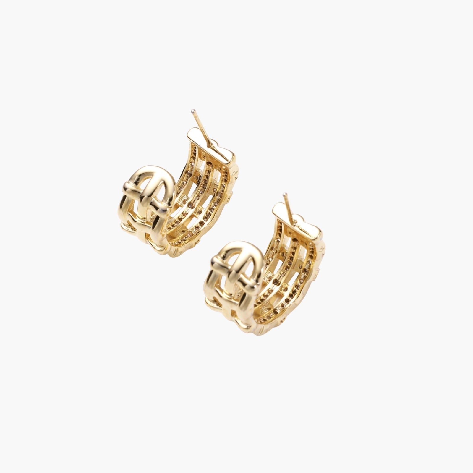Gold-plated geometric hoop earrings with basket-weave lattice design and pavé crystal accents on cream background